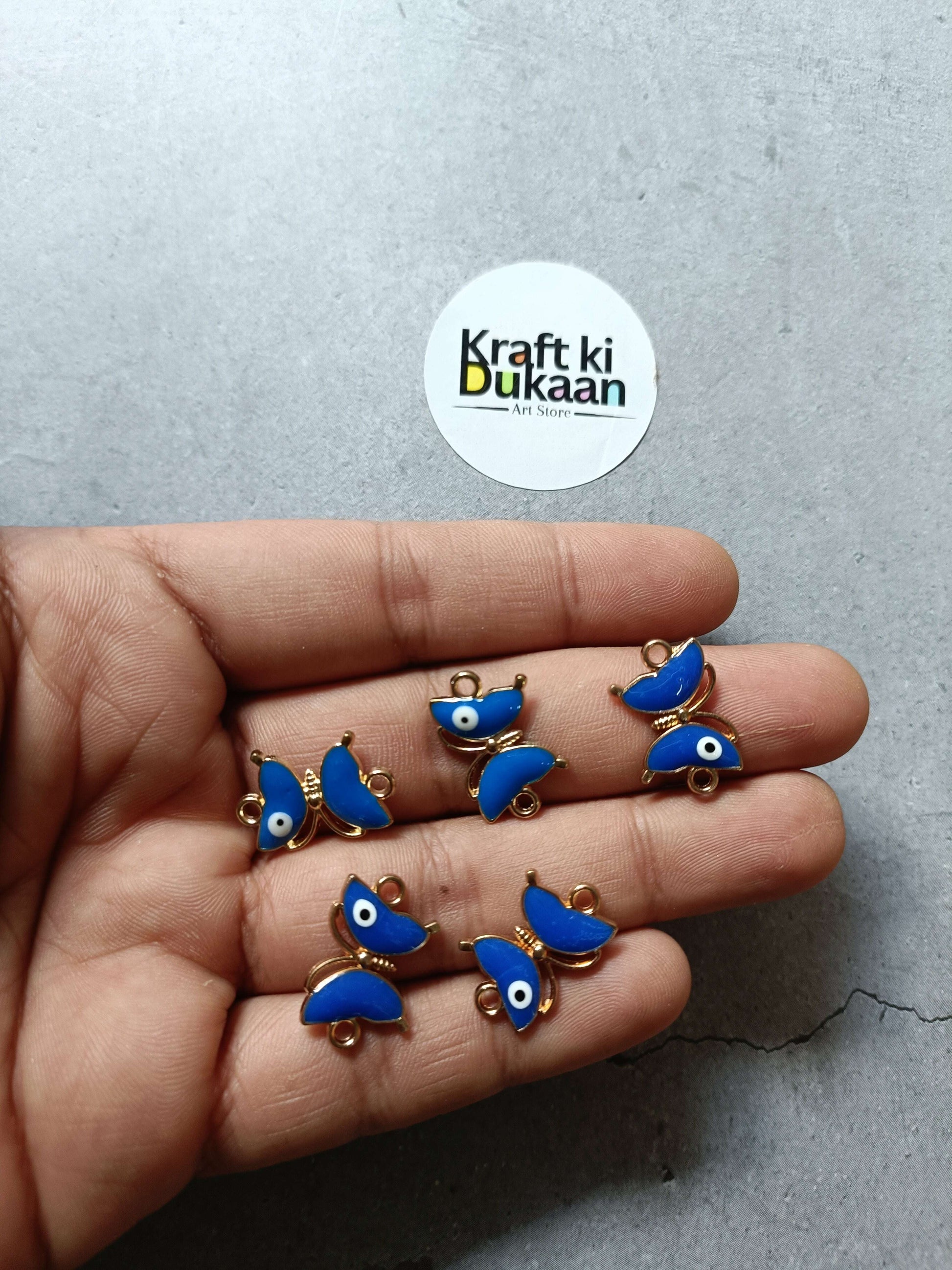 Blue enamel fish bracelet charms with gold-tone loops, small dangling eye detail