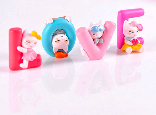 Set of four cartoon animal miniature figurines in pink and blue, seated poses