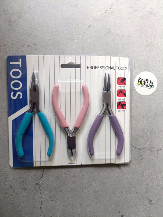 Three-piece pliers set: blue, pink, and purple handles on package card
