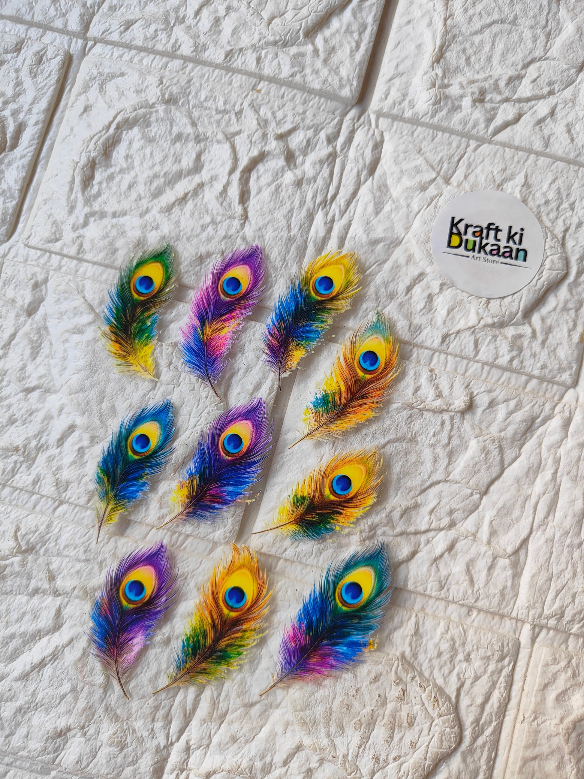 UV DTF peel-off sticker sheet with colorful peacock feather designs, sheet logo included