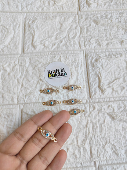 Gold-tone rakhi bracelet pendant with blue oval eye motif and small bead detailing