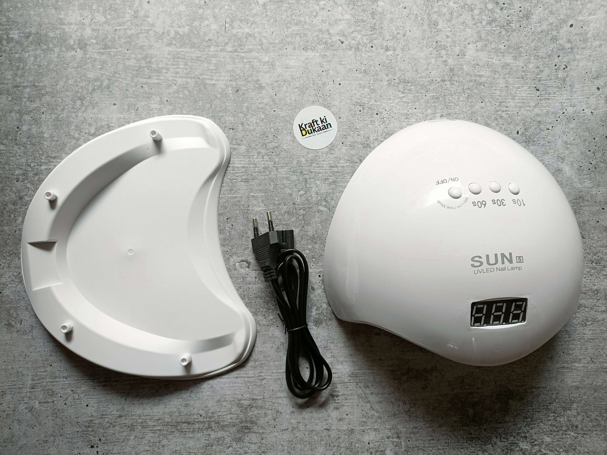 White UV LED nail lamp with digital display and control buttons, with black power cord