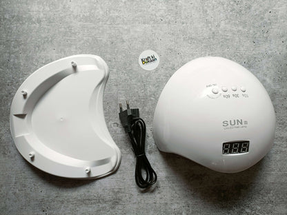 White UV LED nail lamp with digital display and control buttons, with black power cord