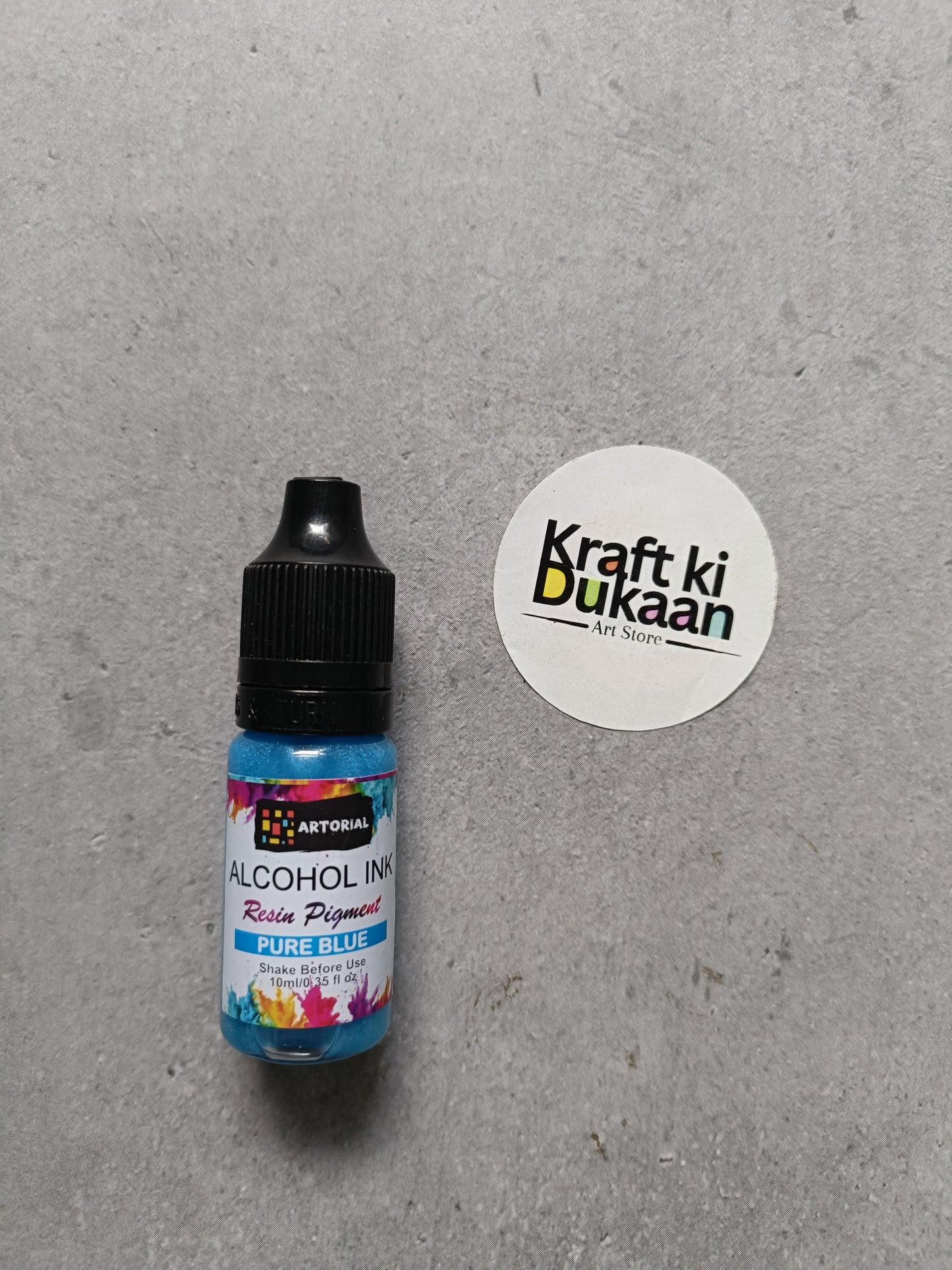 Alcohol ink bottle with black cap, pure blue resin pigment label