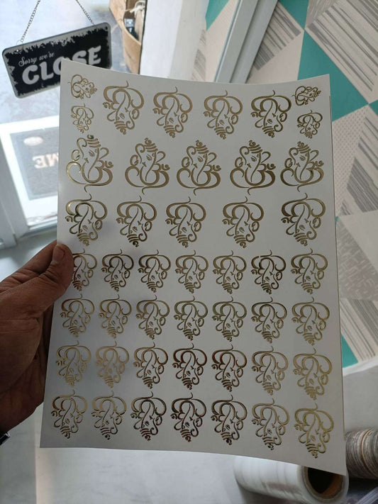 A4 gold embossed sticker sheet with ornate monogram scroll designs on white
