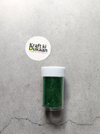 Emerald green chunky glitter powder jar with white lid.