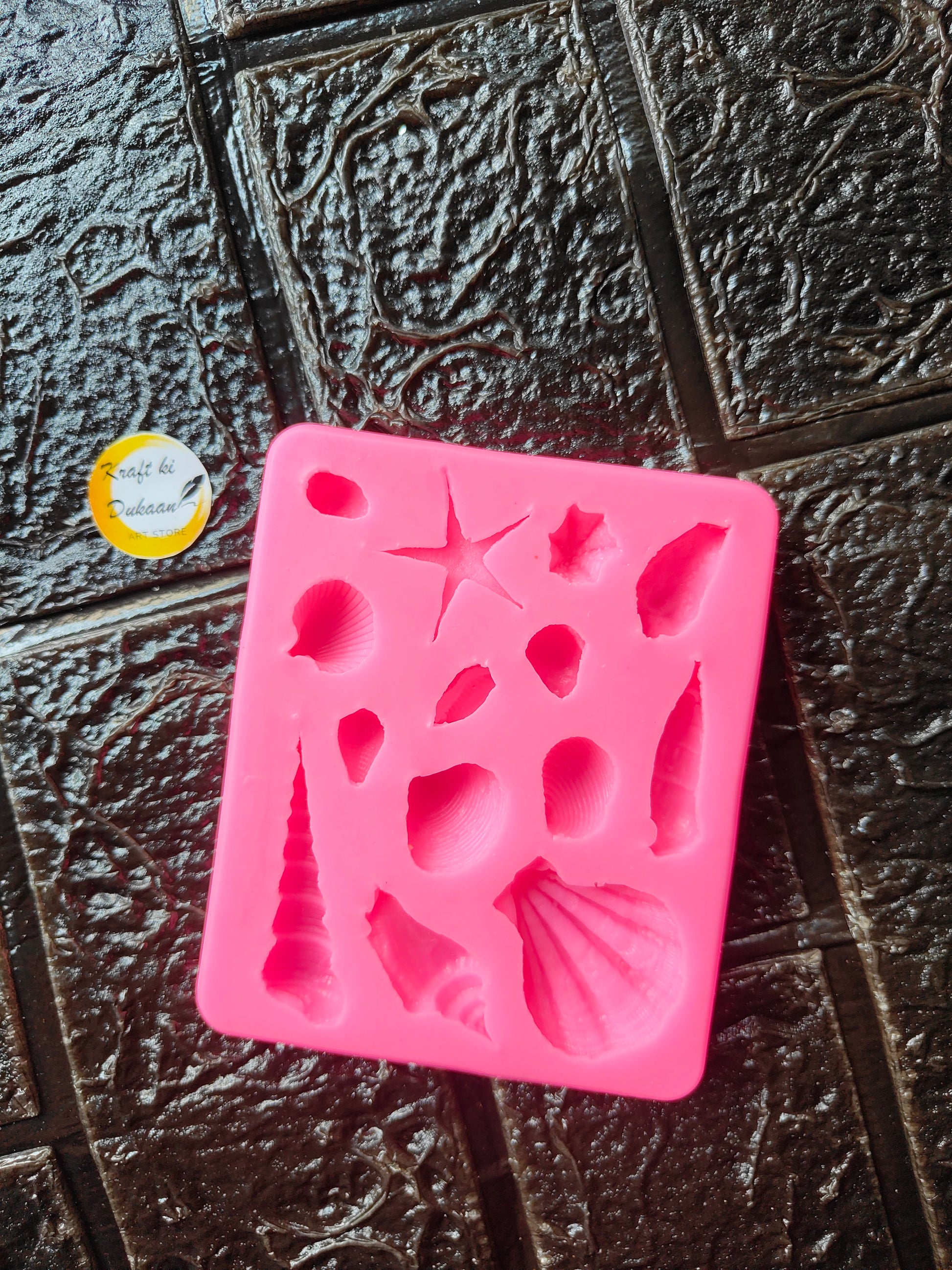 Pink silicone seashell mold with 14 cavities and raised shell shapes