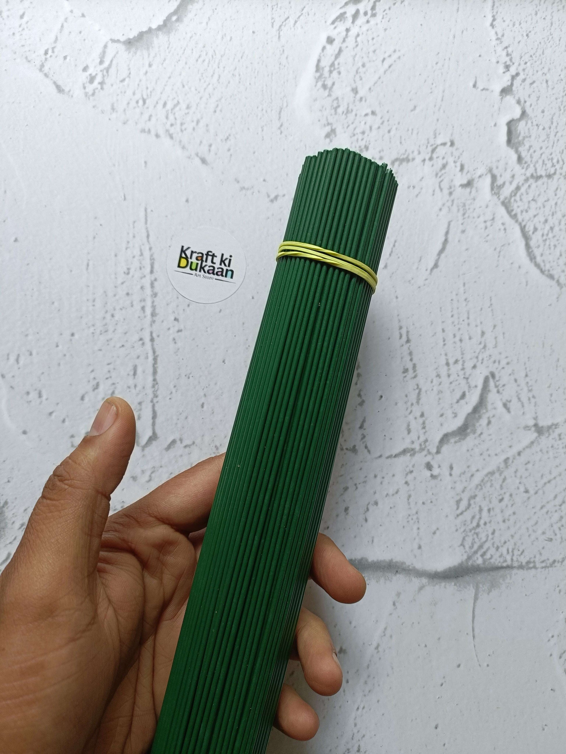 Green plastic-coated wire sticks bundle, tied with rubber band