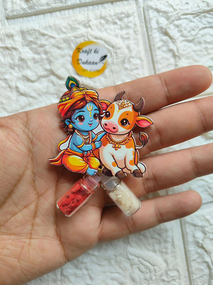 Roli Chawal Bottle Set A3 with cartoon deity and cow; two mini vials, red and cream.