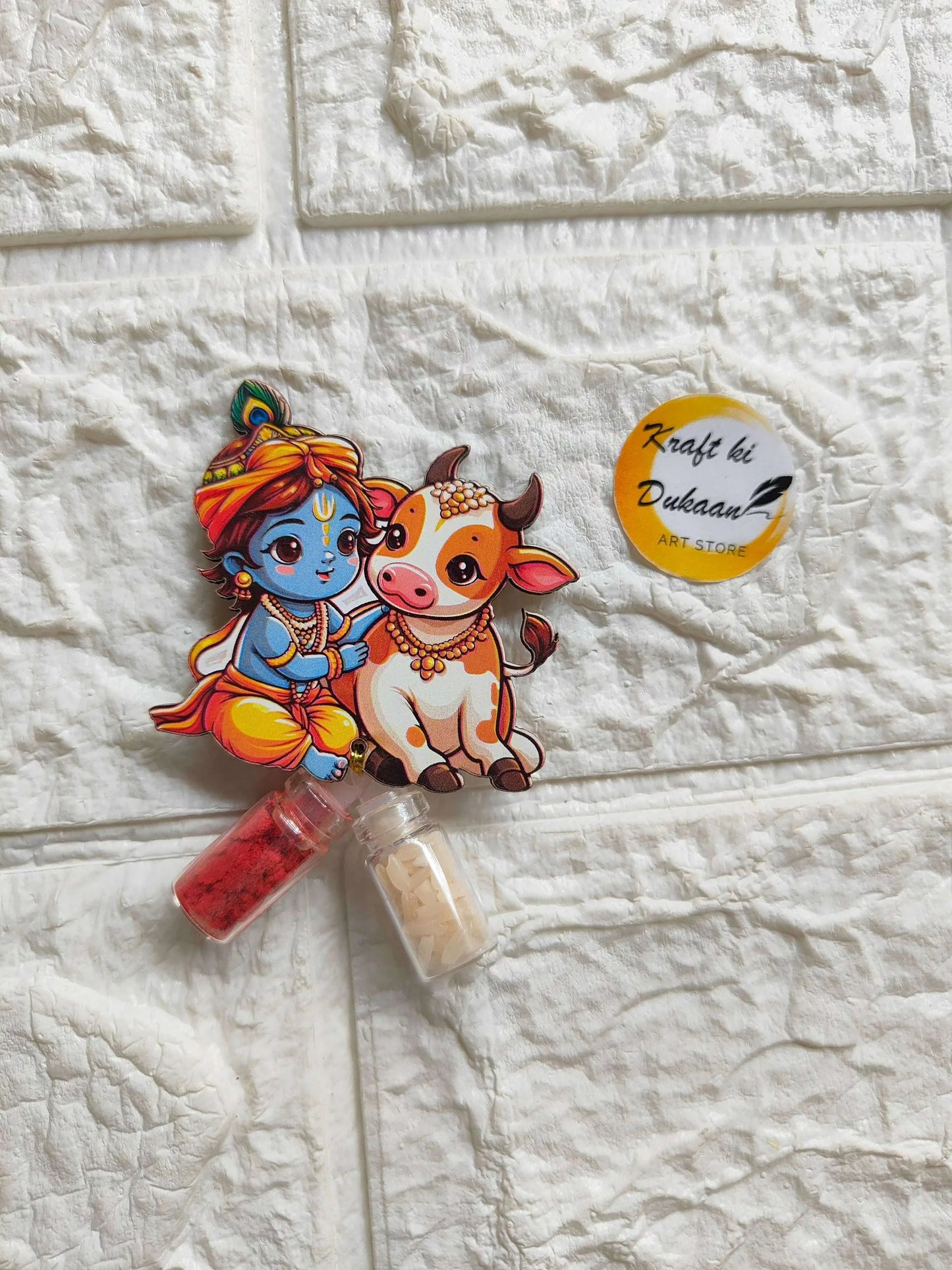 Roli Chawal Bottle Set A3: cartoon girl and cow sticker with two small vials, red & cream.