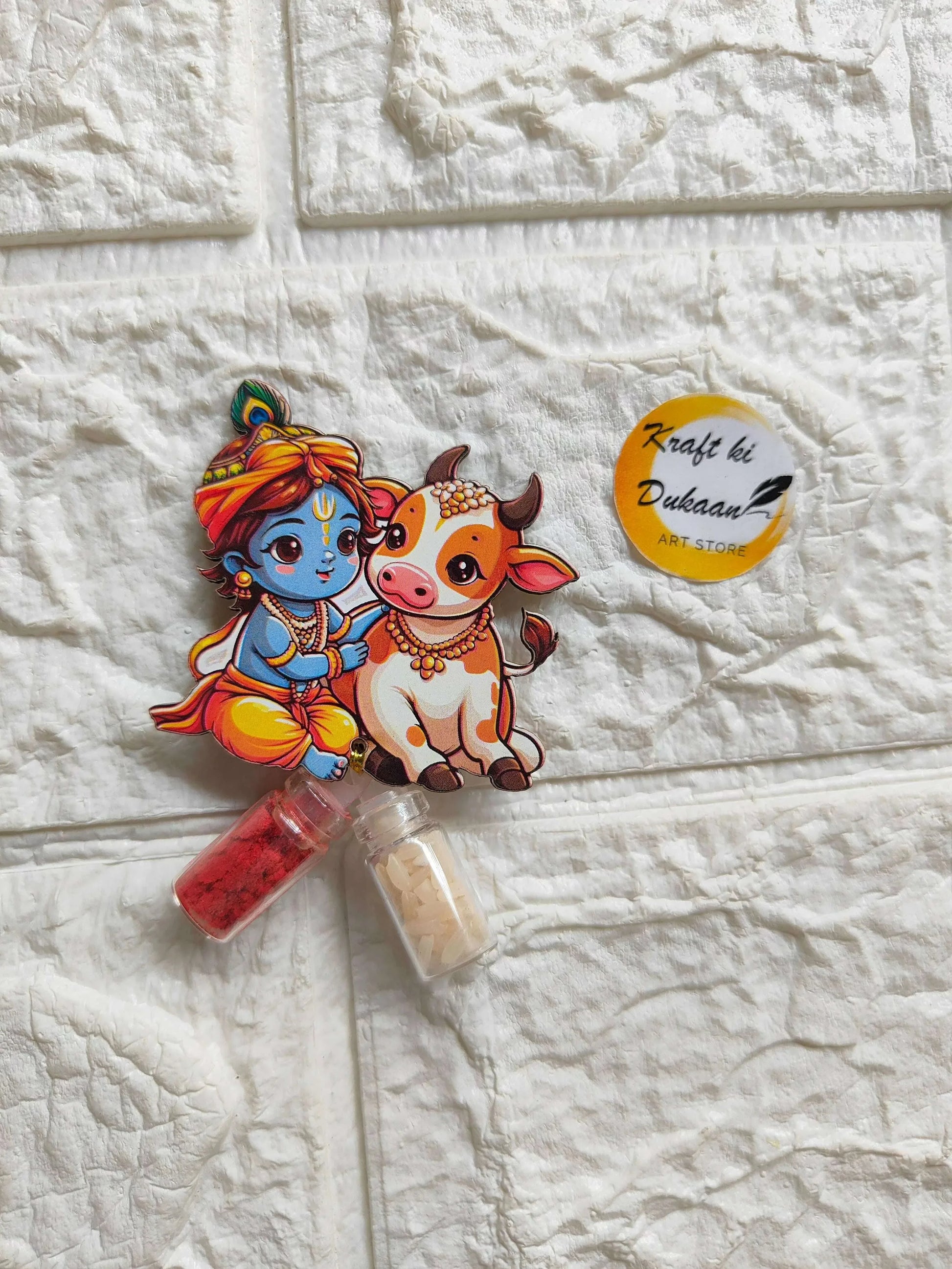Roli Chawal Bottle Set A3: cartoon girl and cow sticker with two small vials, red & cream.