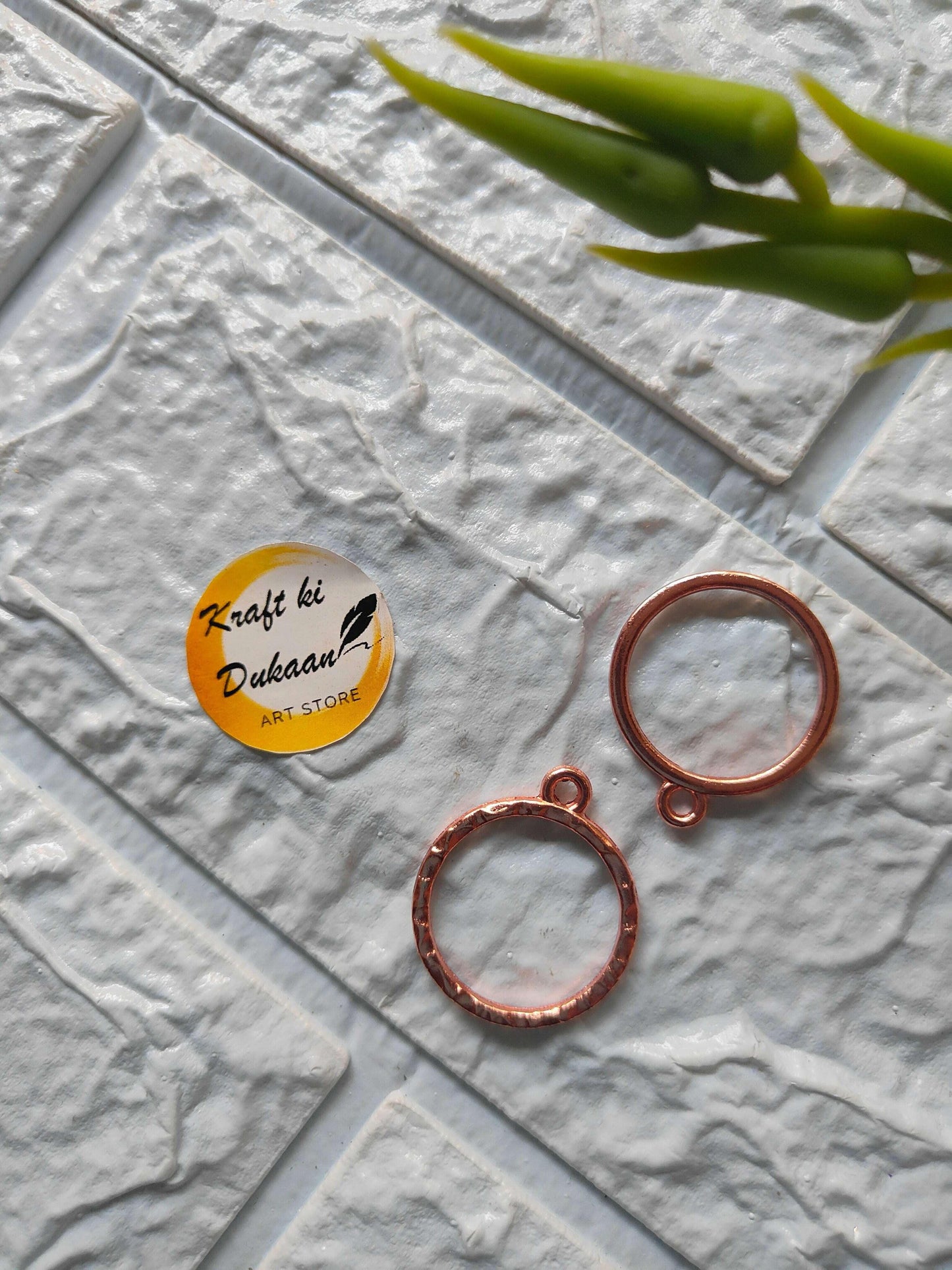 Round bezel pendant loops in rose gold tone, with top eyelets