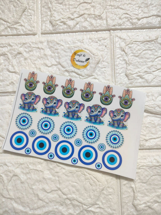 UV DTF peel-off sticker sheet with colorful hamsa hands, elephants, and blue circle patterns