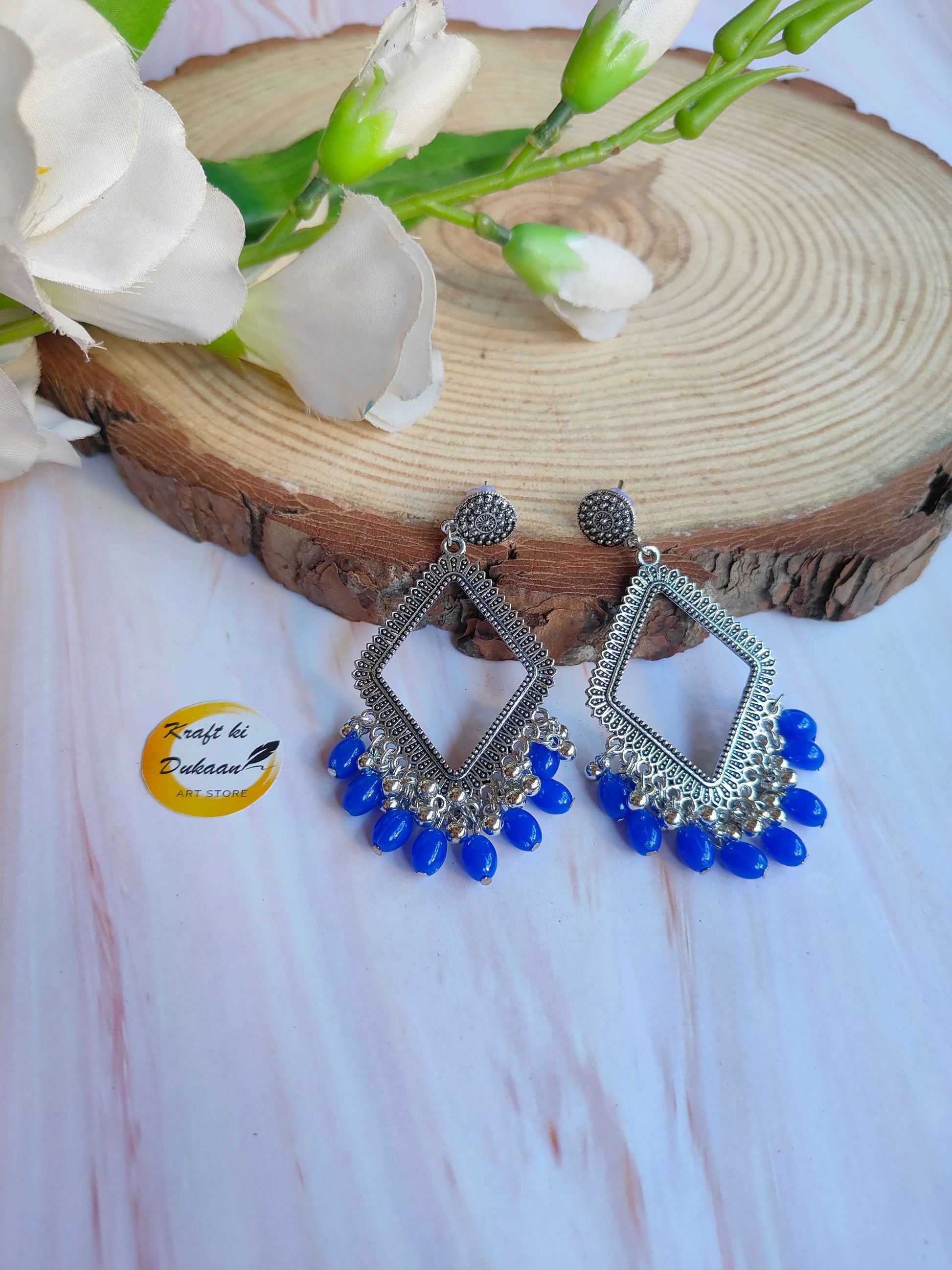 silver-jhumka-earrings-blue-bead-dangling-style