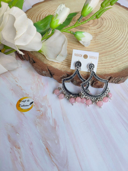 Stylish silver jhumka earrings with pink beads, perfect for festive occasions and everyday wear