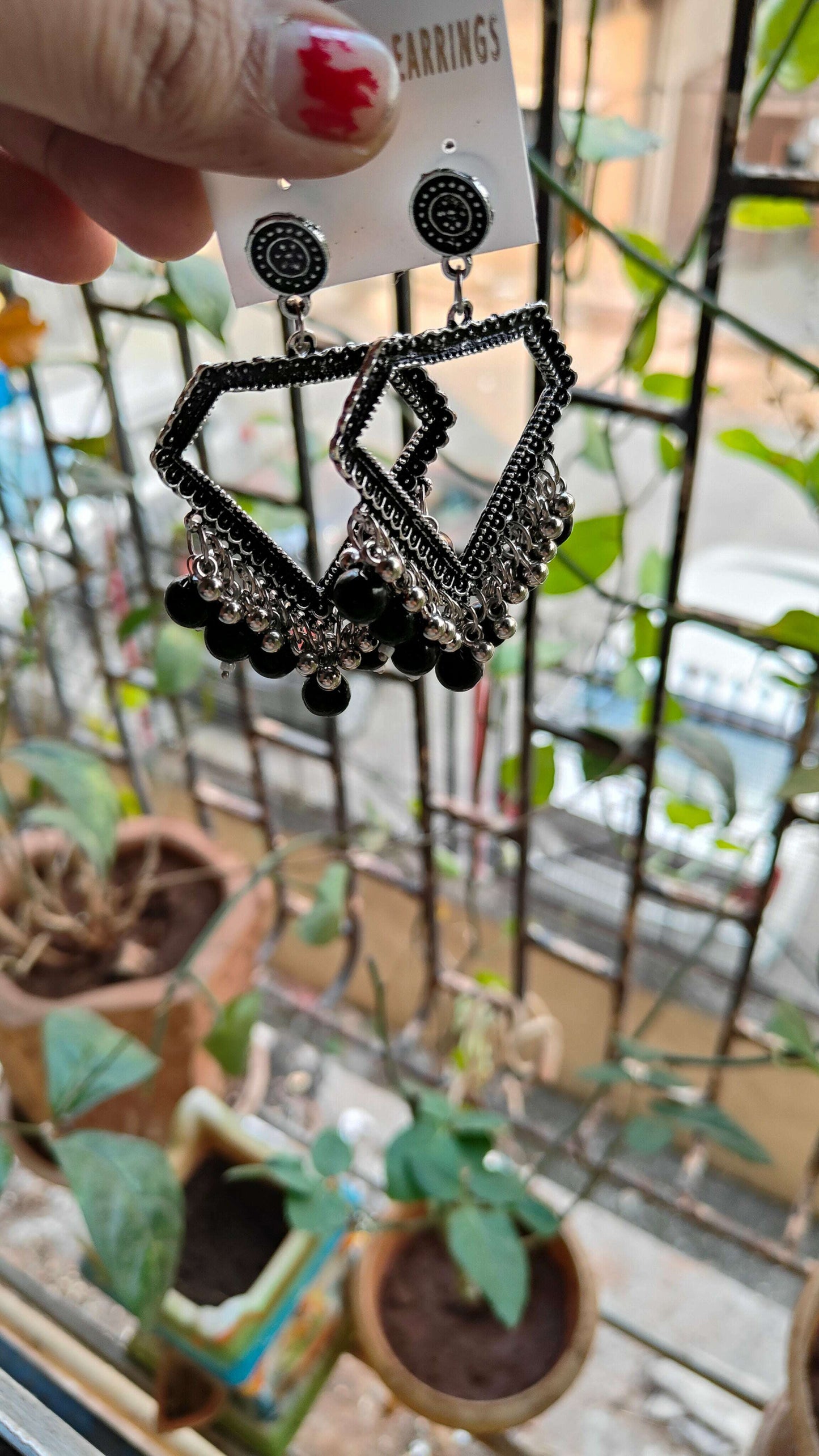 silver-jhumka-earrings-with-beads-black-angled-view