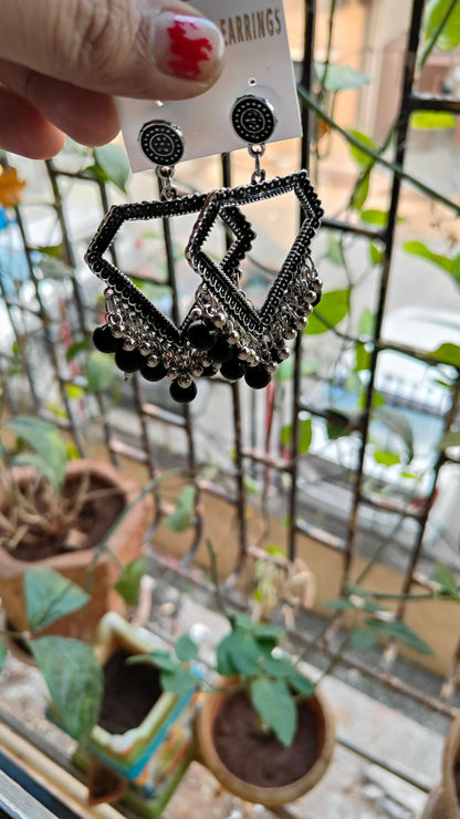 silver-jhumka-earrings-with-beads-black-angled-view