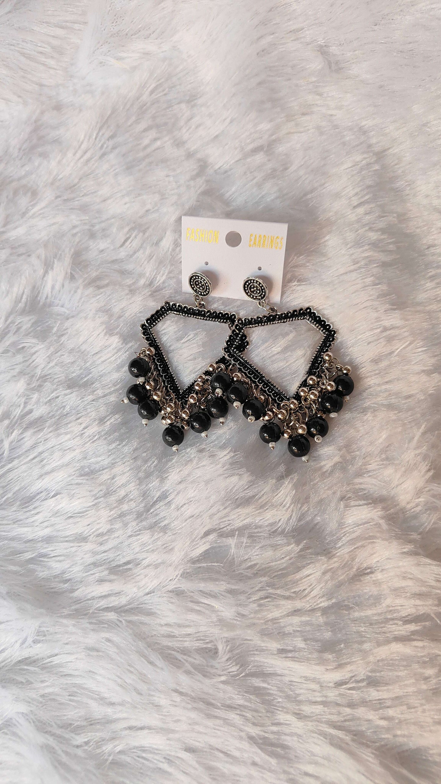 silver-jhumka-earrings-with-beads-black-on-fur-background