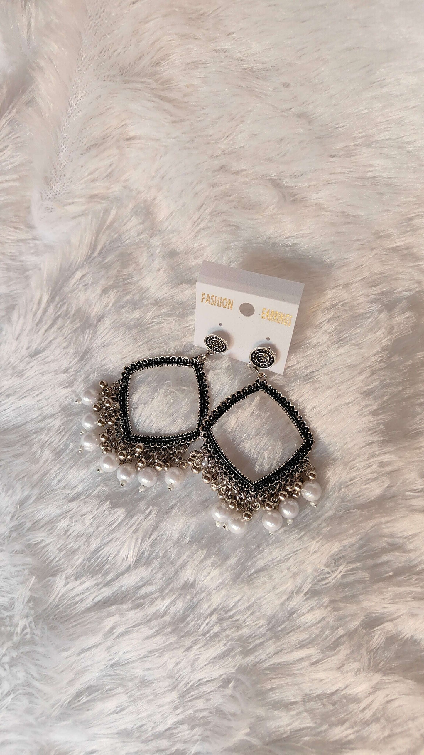 silver-jhumka-earrings-with-beads-close-up-display