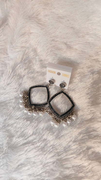 silver-jhumka-earrings-with-beads-close-up-display