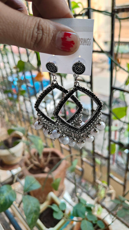 silver-jhumka-earrings-with-beads-hanging-display