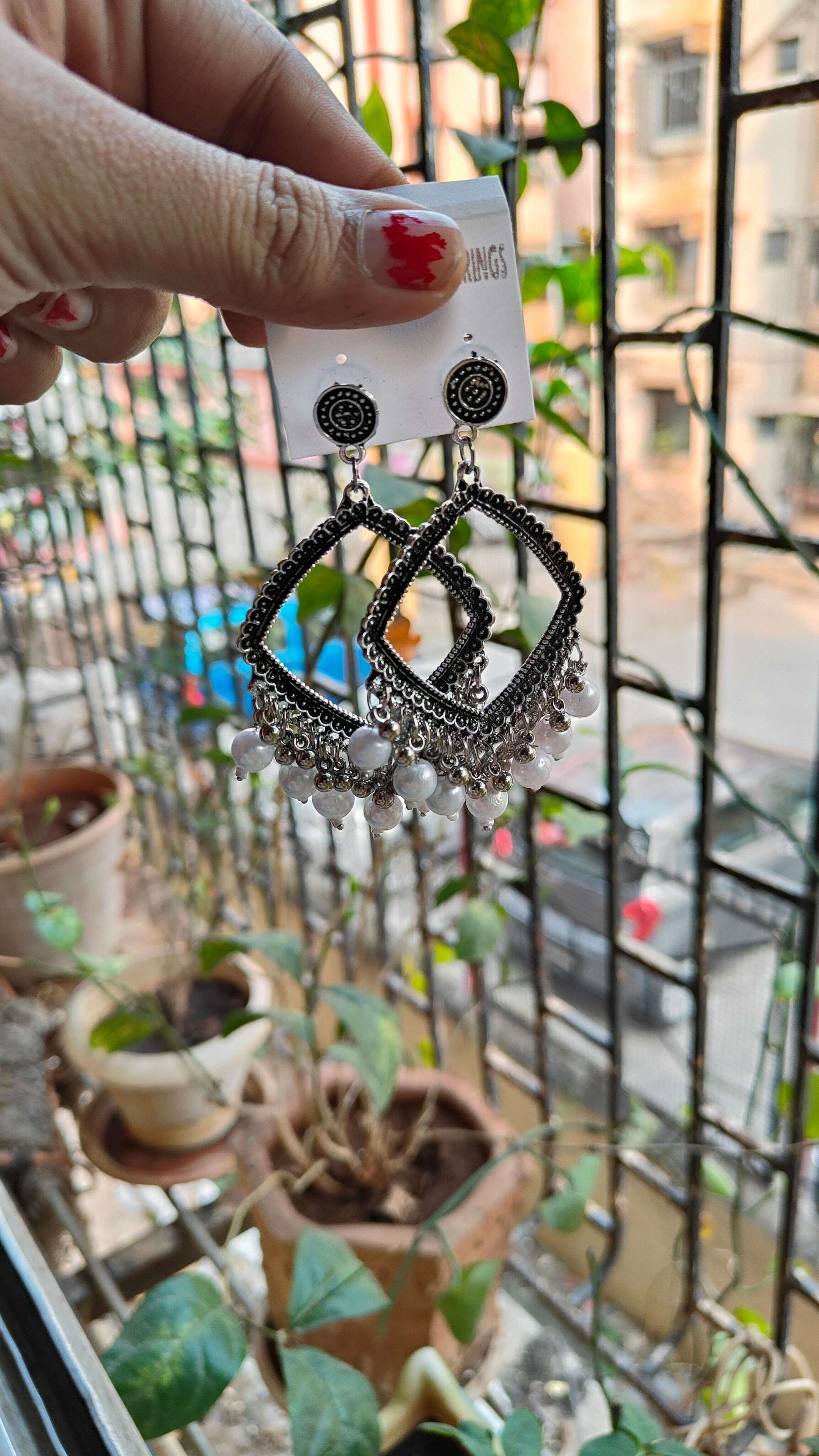 silver-jhumka-earrings-with-beads-outdoor-shot