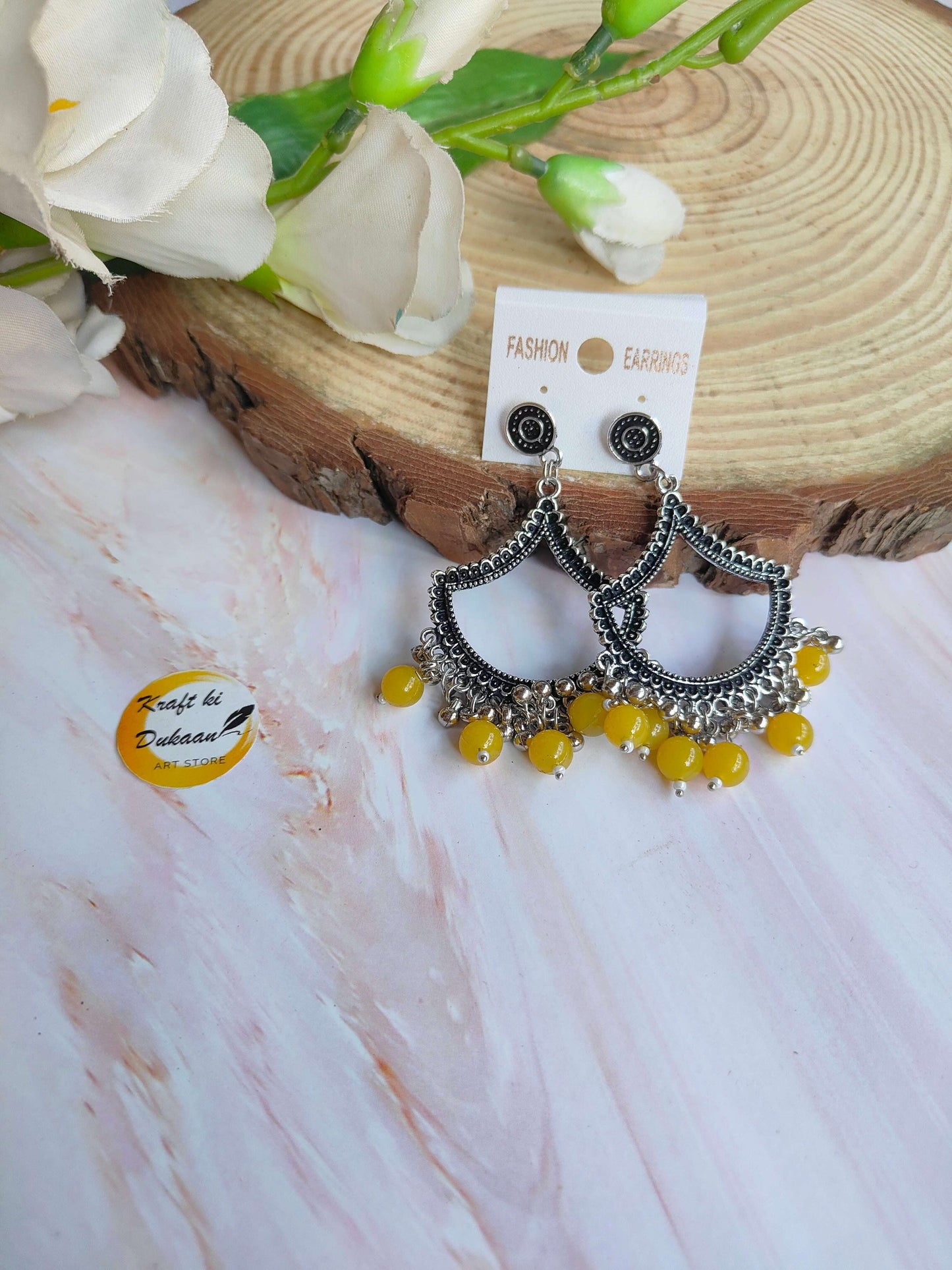 Stylish silver jhumka earrings with beads in intricate design and yellow accents from Kraft ki Dukaan