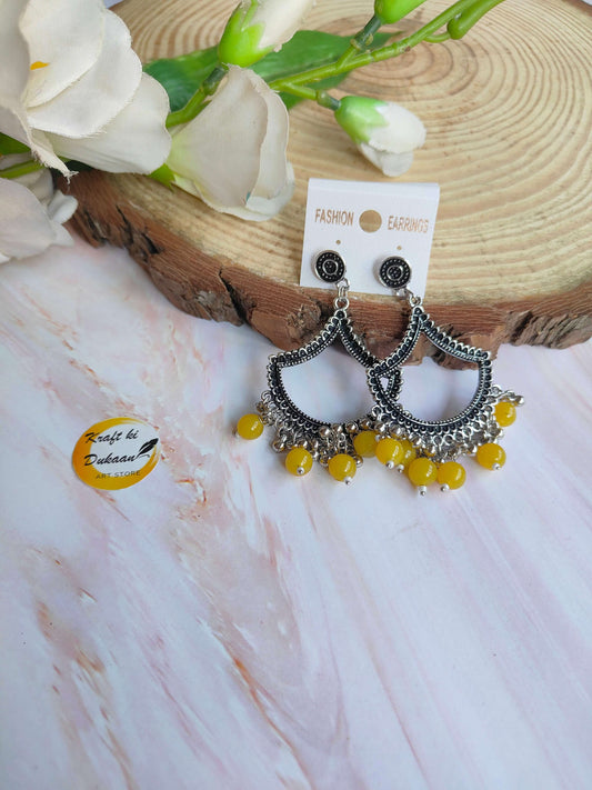 Stylish silver jhumka earrings with beads in intricate design and yellow accents from Kraft ki Dukaan