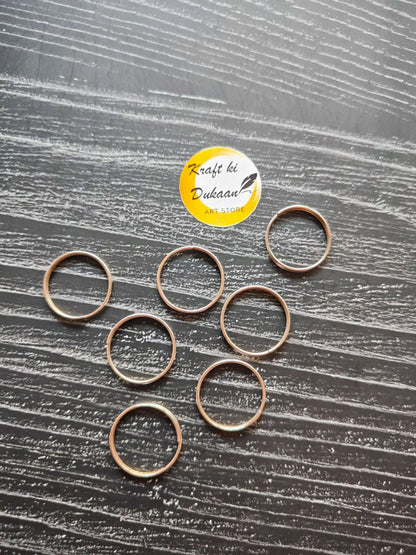 Gold-toned circle metal rings with open loop shape, shown together.