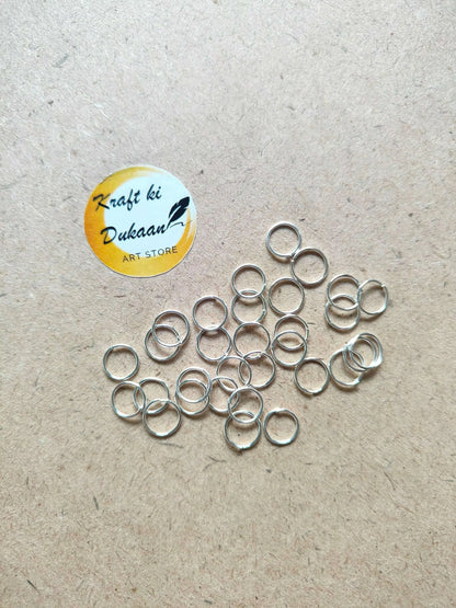 Silver-tone circle metal rings, scattered open loops with varied ring sizes.