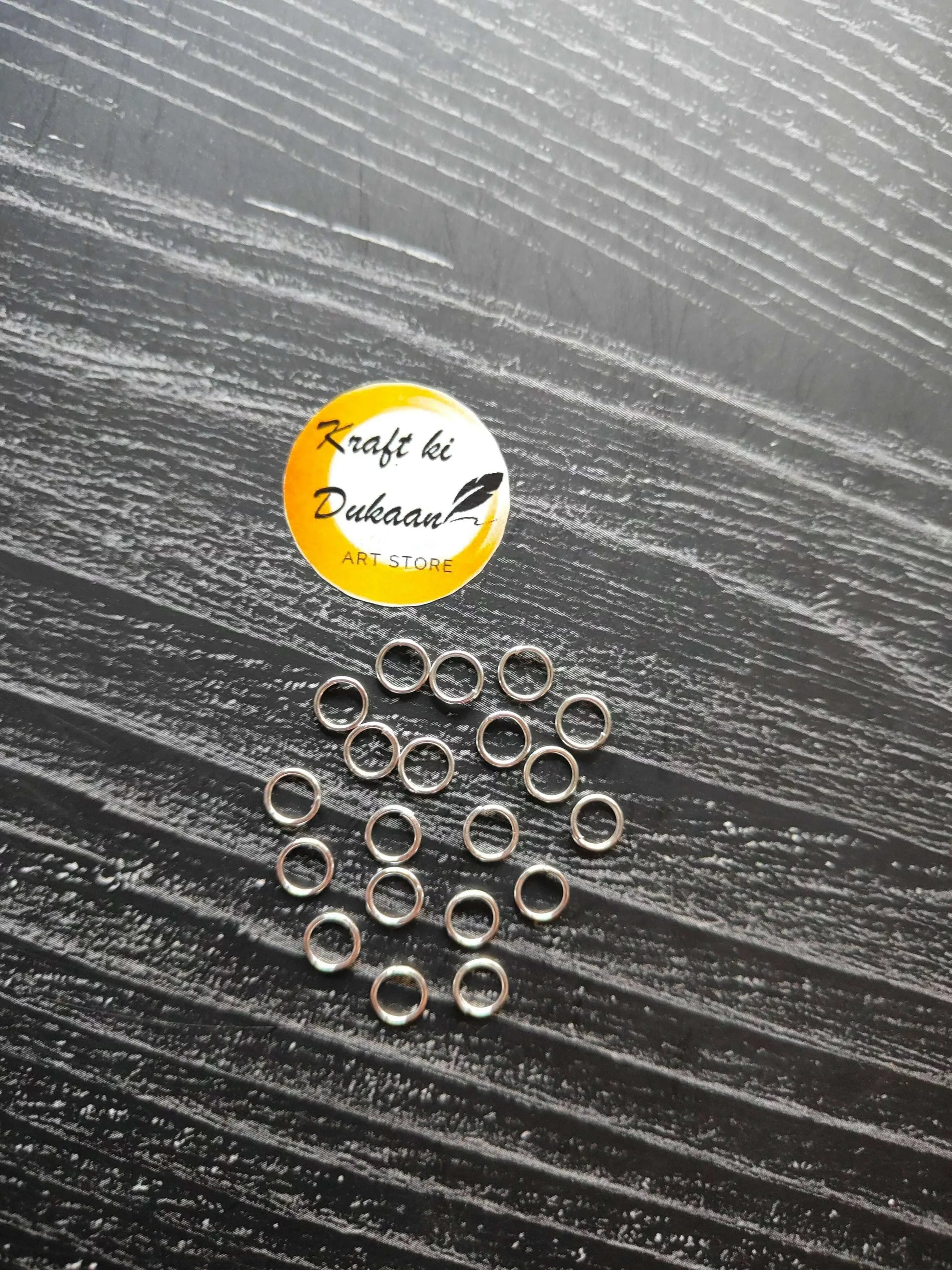 Silver-tone circle metal rings, small open loops (assorted pile).