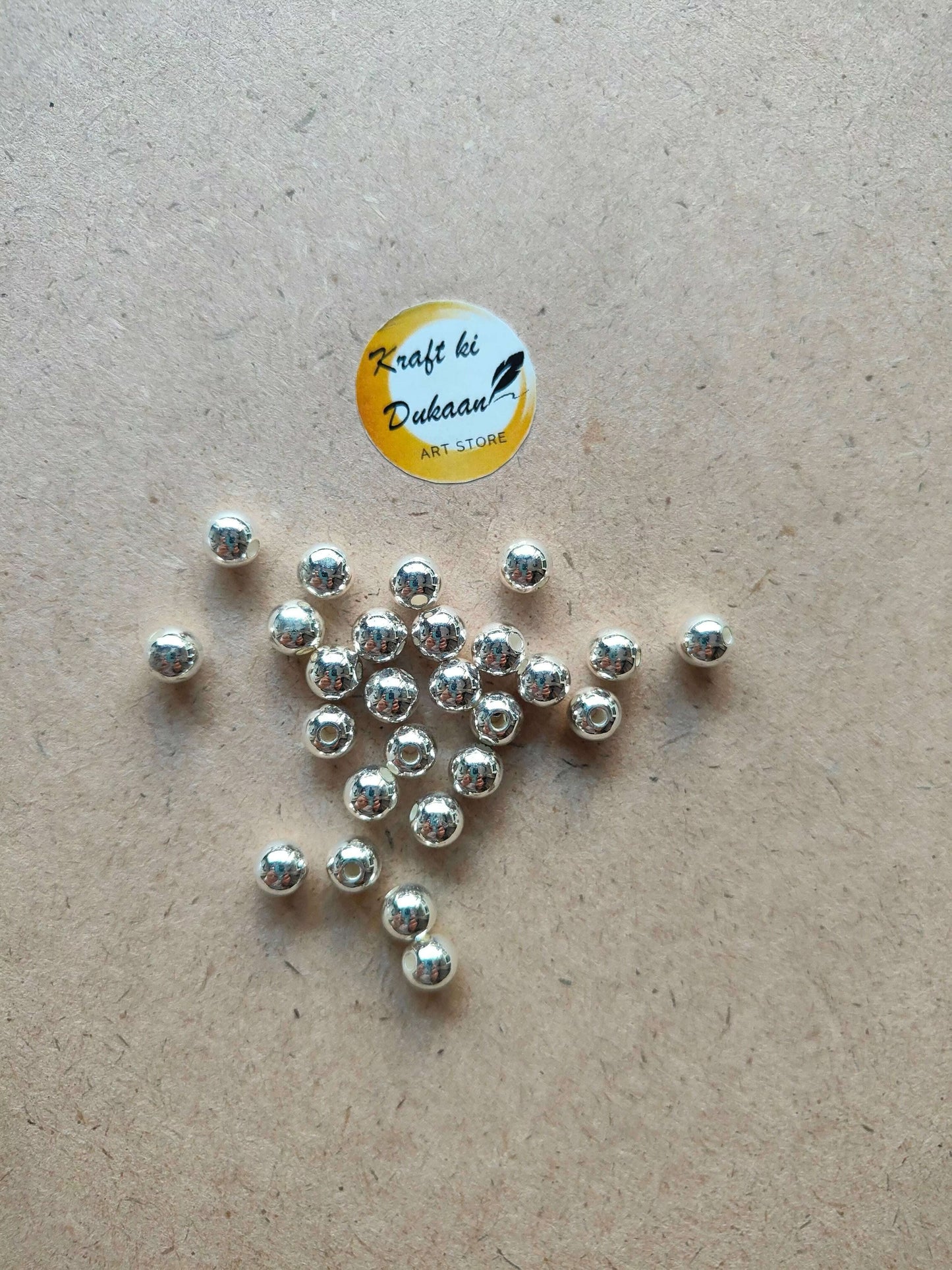silver-pearl-beads-for-jewelry-making-on-brown-paper