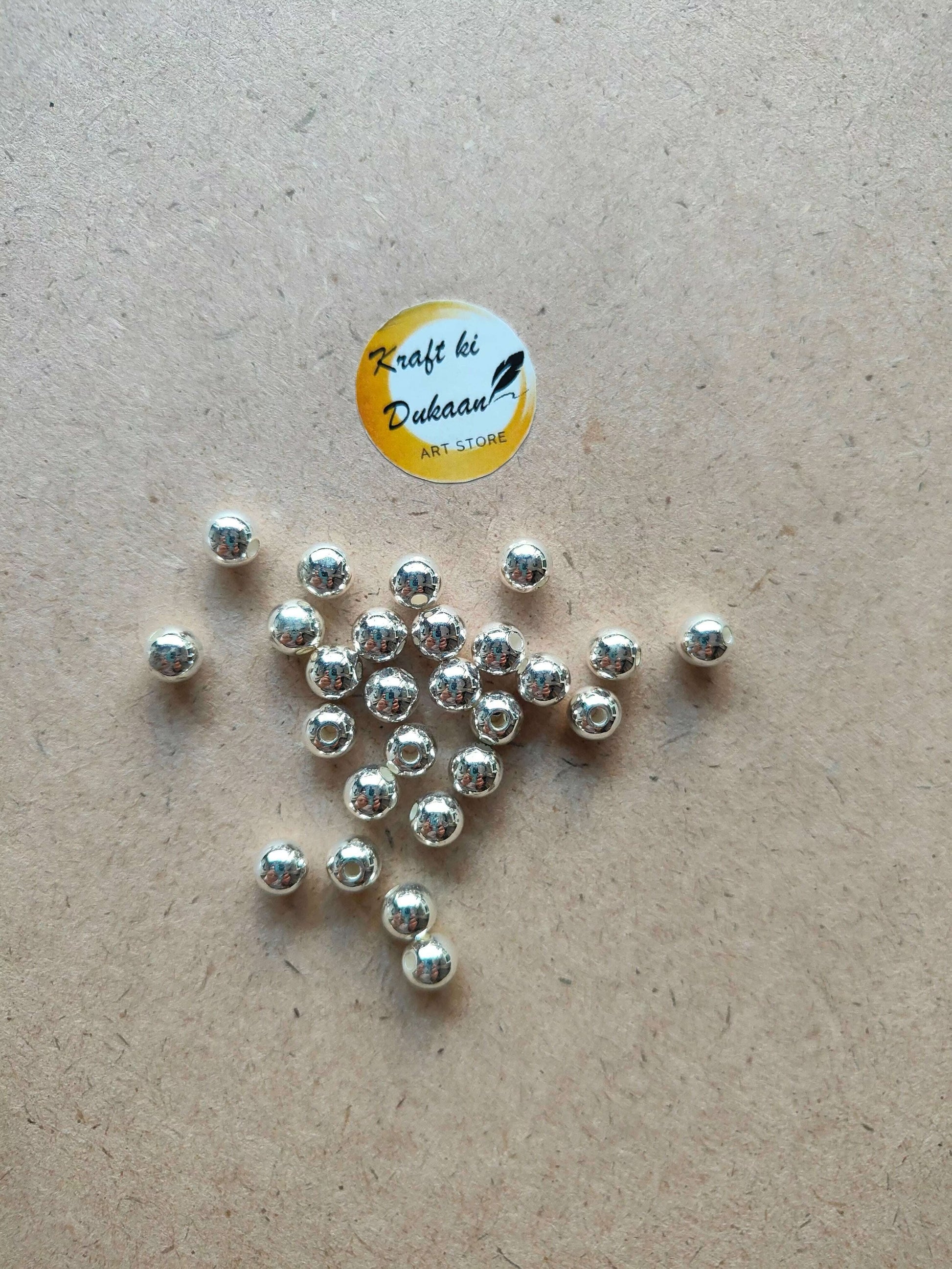 silver-pearl-beads-for-jewelry-making-on-brown-paper