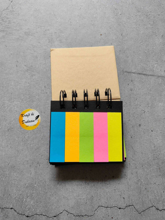 Spiral sticky note pad with multicolor sticky sheets and black rings on kraft cover