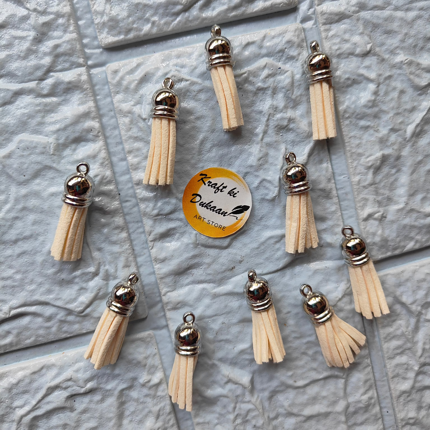 Set of silver leather tassel charms for crafting, featuring delicate designs ideal for accessories