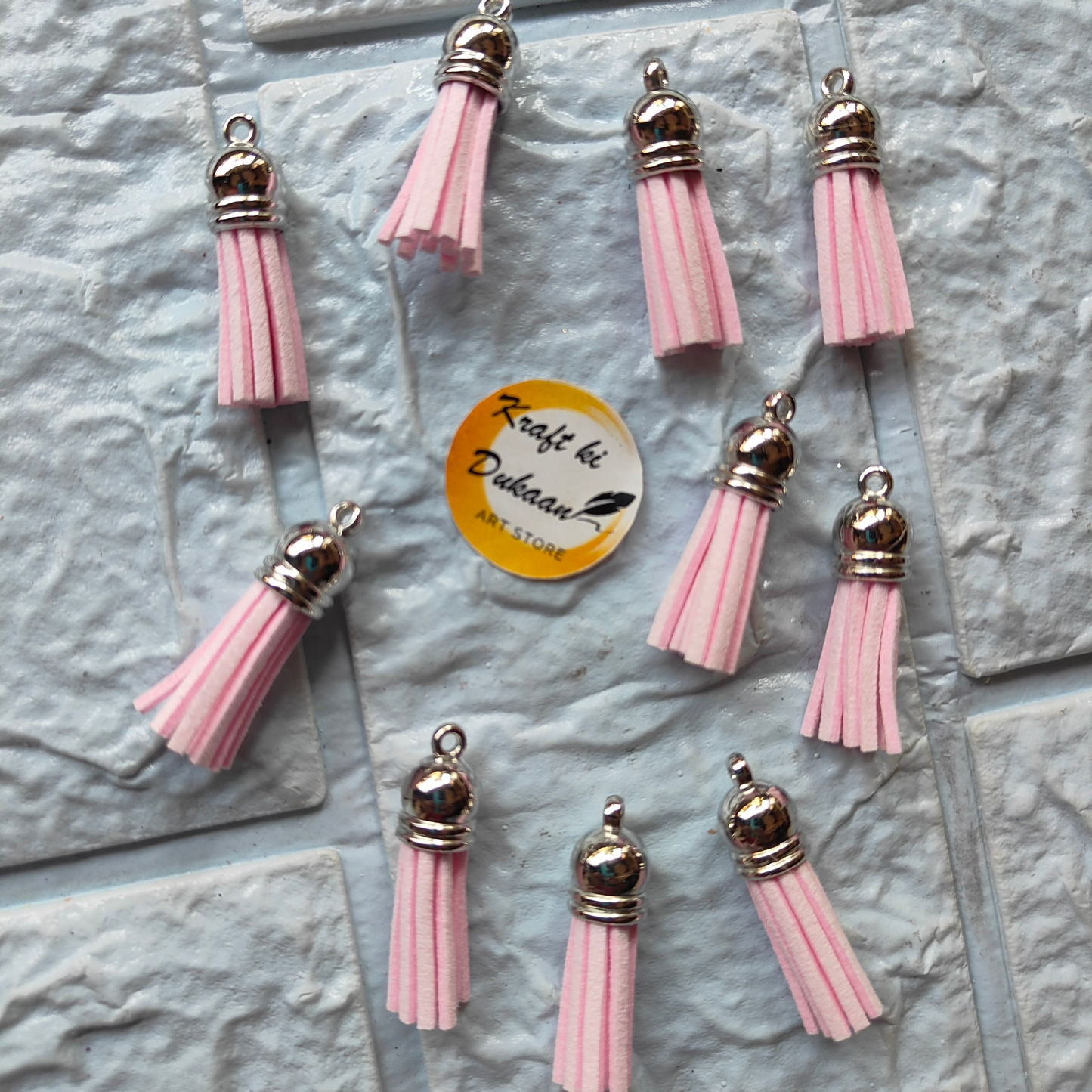 Set of pink leather tassel charms with silver accents for crafting, featuring silver leather tassel charms