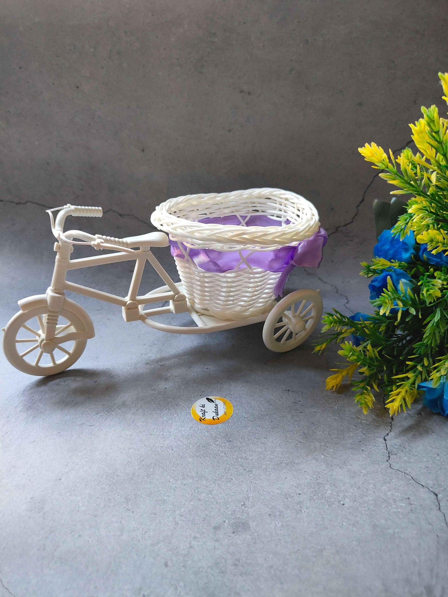 Charming wicker cycle basket decor with a purple ribbon, perfect for home or event styling