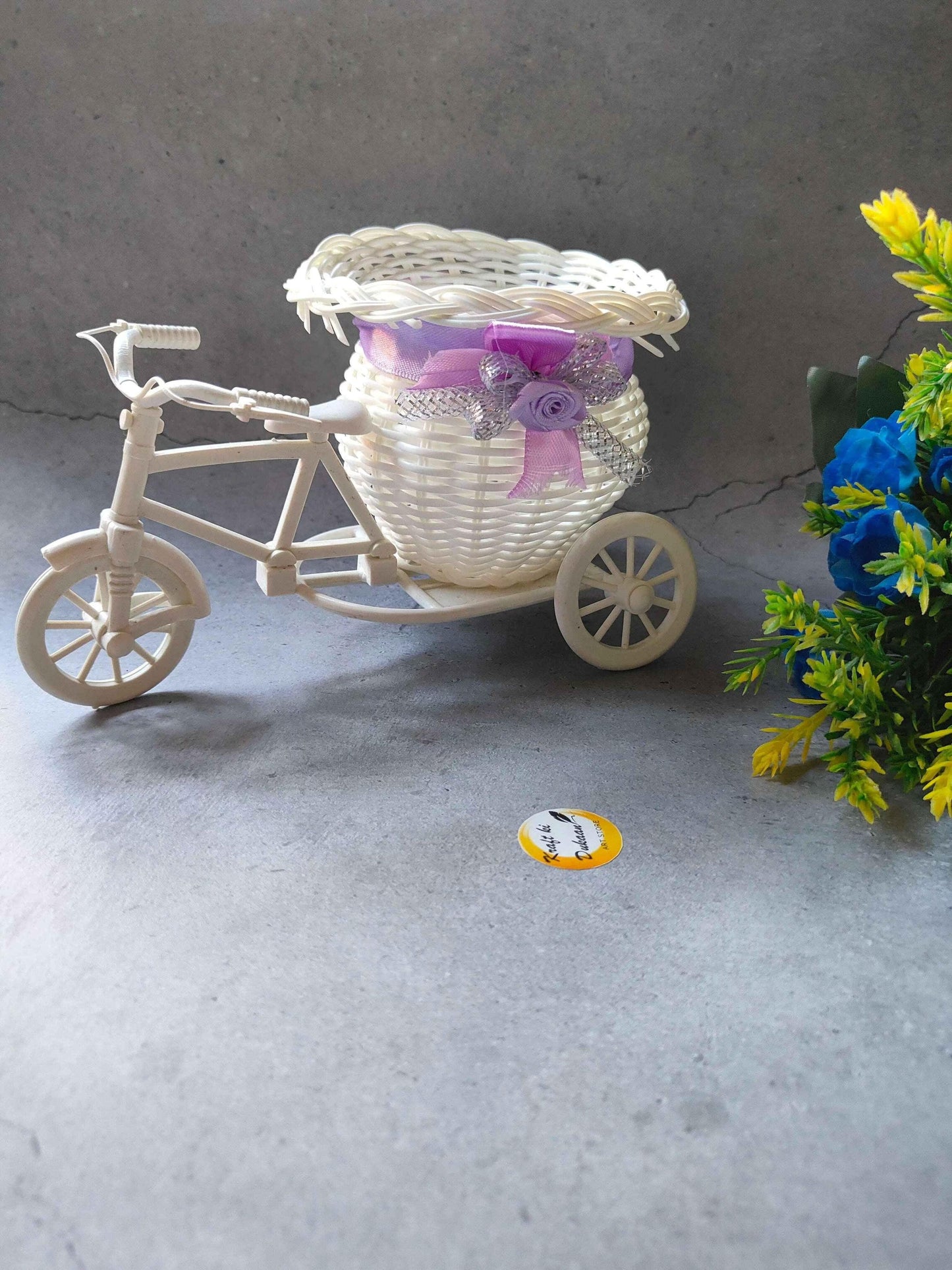 Charming wicker cycle planter basket with decorative flowers, perfect for home decor