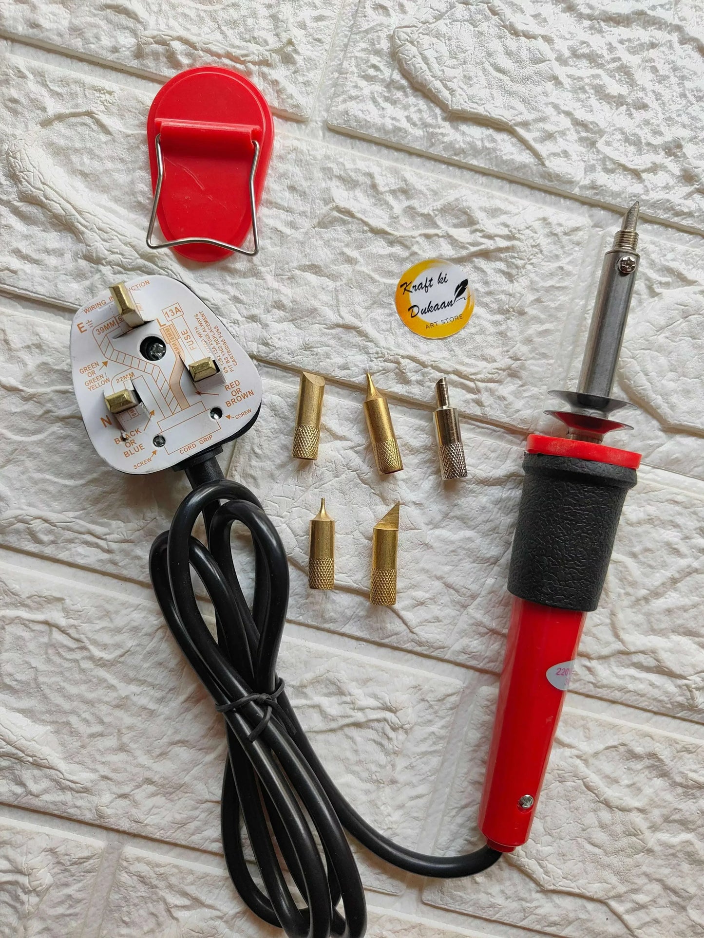 Soldering set with red iron handle, black cable, and multiple brass tips