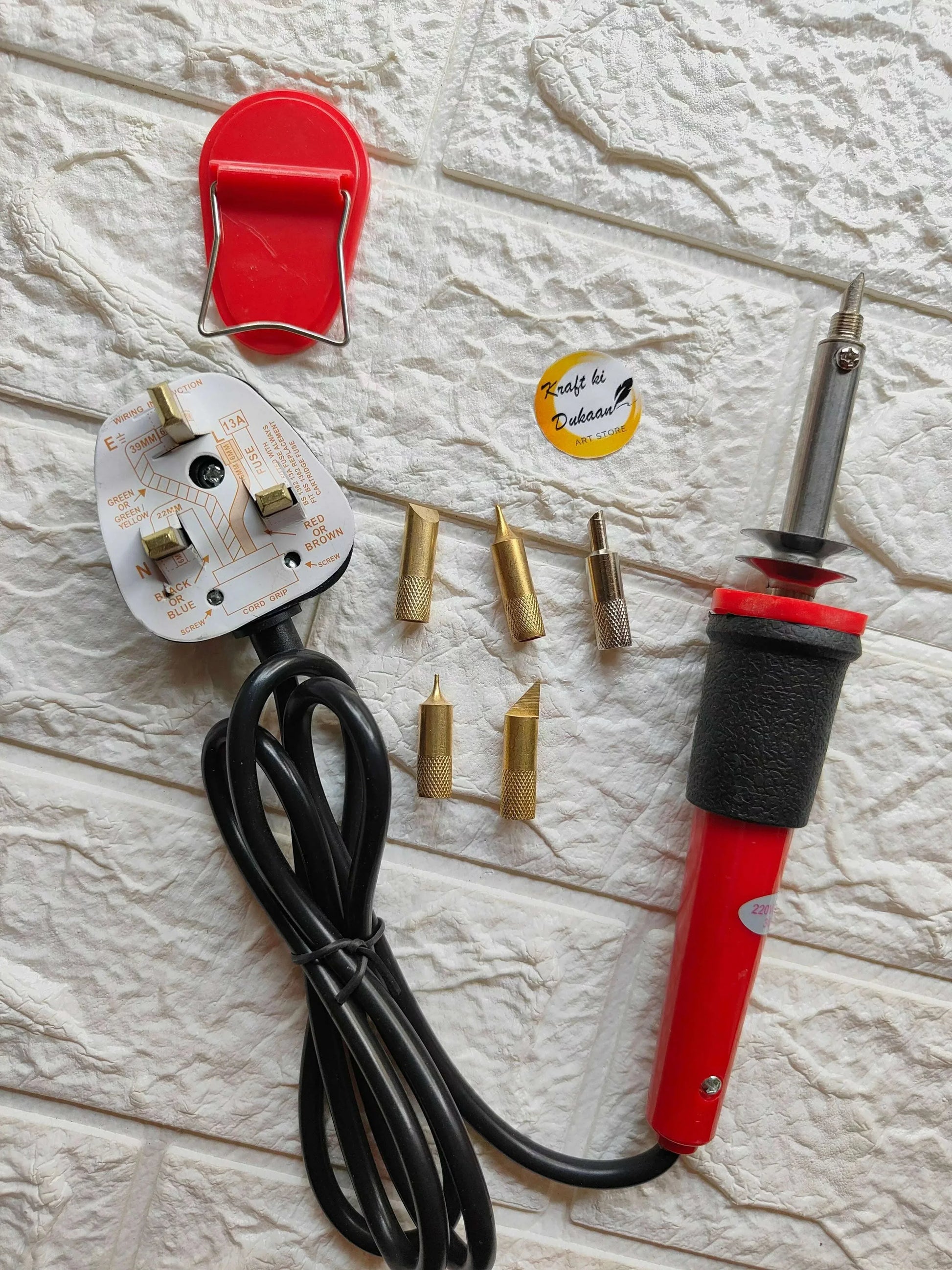 Soldering set with red iron handle, black cable, and multiple brass tips