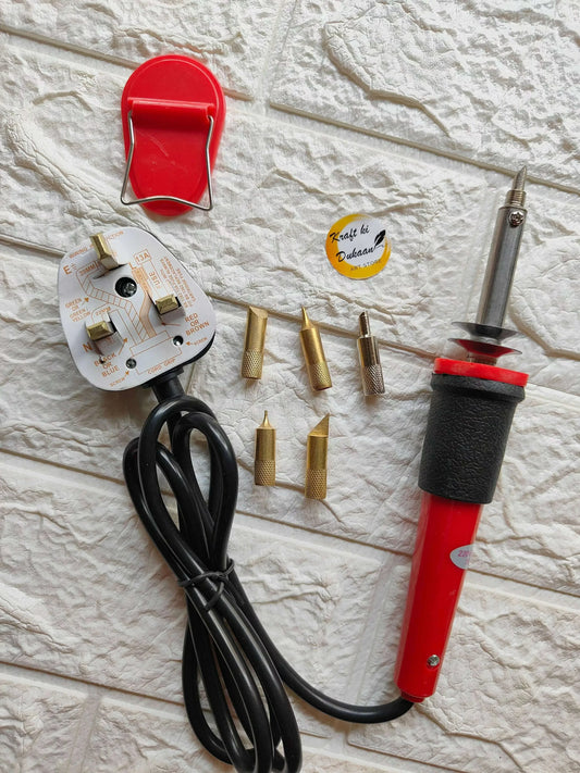 Soldering set with red iron handle, black cable, and multiple brass tips