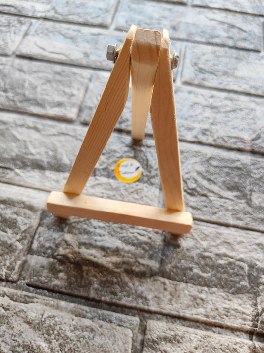 Kraft ki Dukaan 6 inch wooden easel stand with natural wood finish against a stone tile background